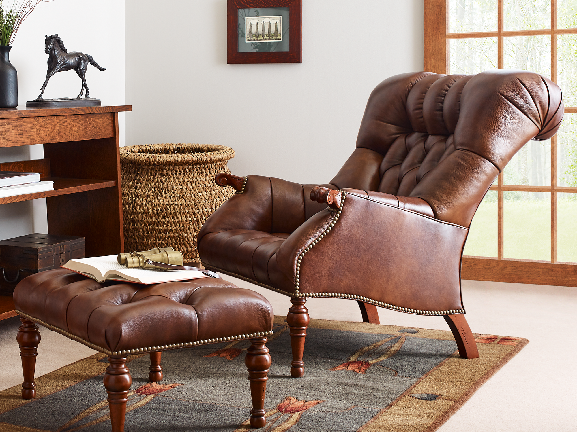 Stickley Fine Leather — Rialto high-back leather club chair in a warm pecan finish with decorative nailhead trim and a matching footstool.