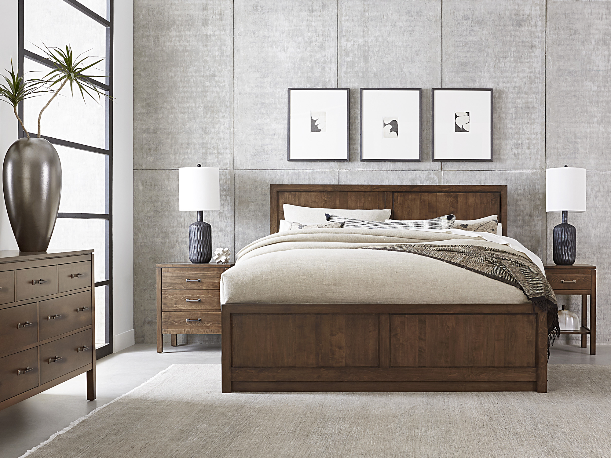 Origins by Stickley — solid wood Dwyer bed featuring a clean-lined headboard with vertical slat details and a matching nightstand in a light, natural finish.
