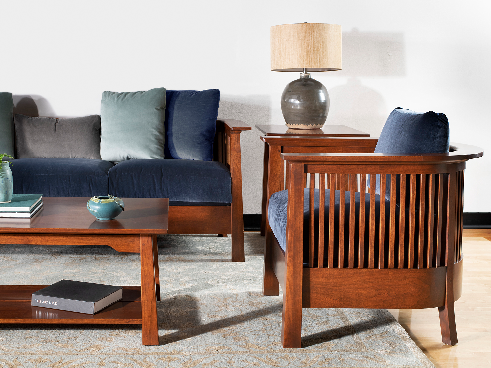 Stickley Park Slope Collection — solid wood sofa and matching lounge chair featuring sculptural curved arms and a wood-slat design with neutral upholstery.