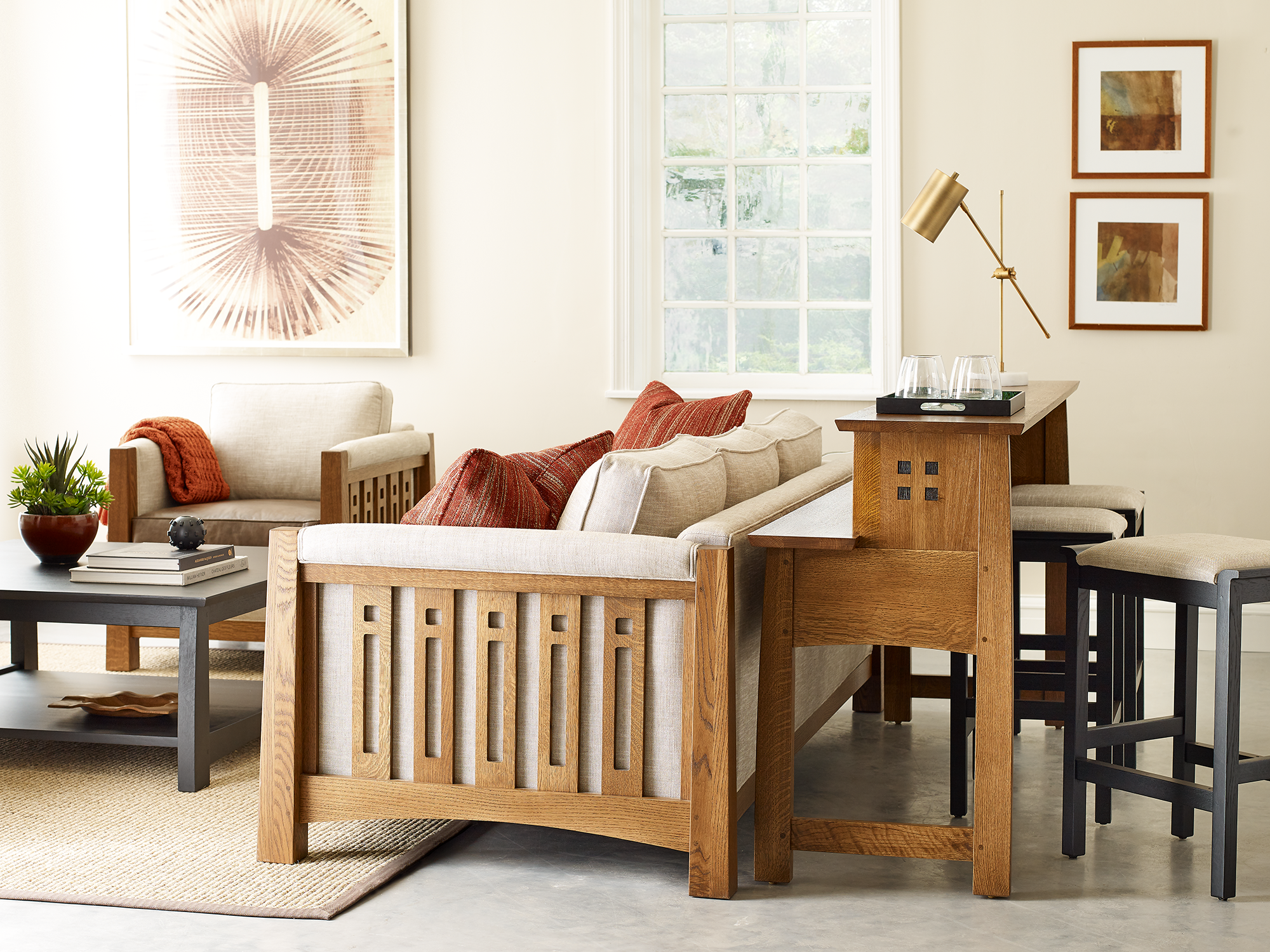 Stickley Highlands Collection — solid wood sofa featuring decorative pierced-slat arms and dark upholstered cushions in a transitional living room.