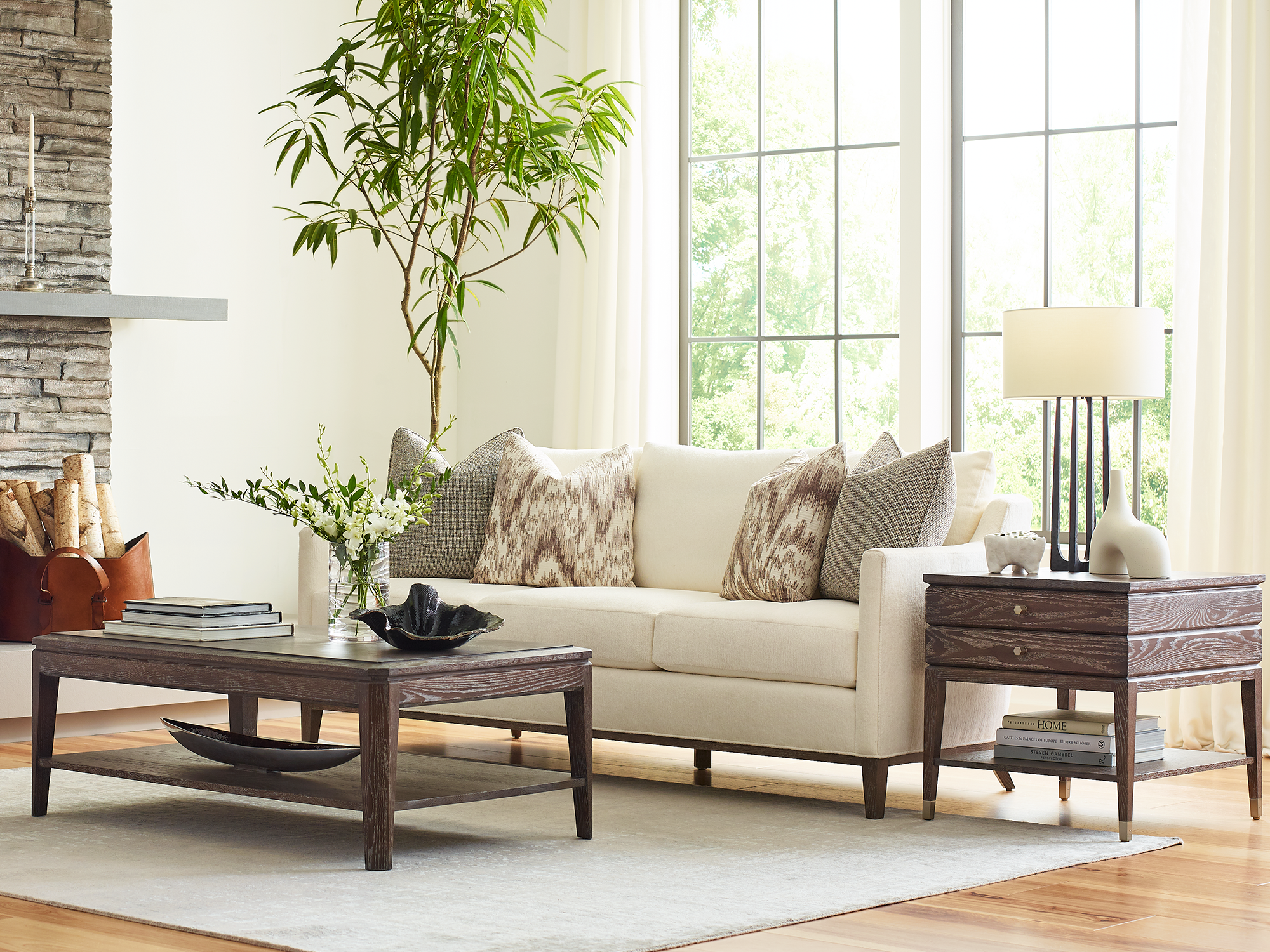 Stickley Maidstone Collection — transitional living room furniture featuring a dark wood coffee table and matching end table with a cream upholstered sofa.