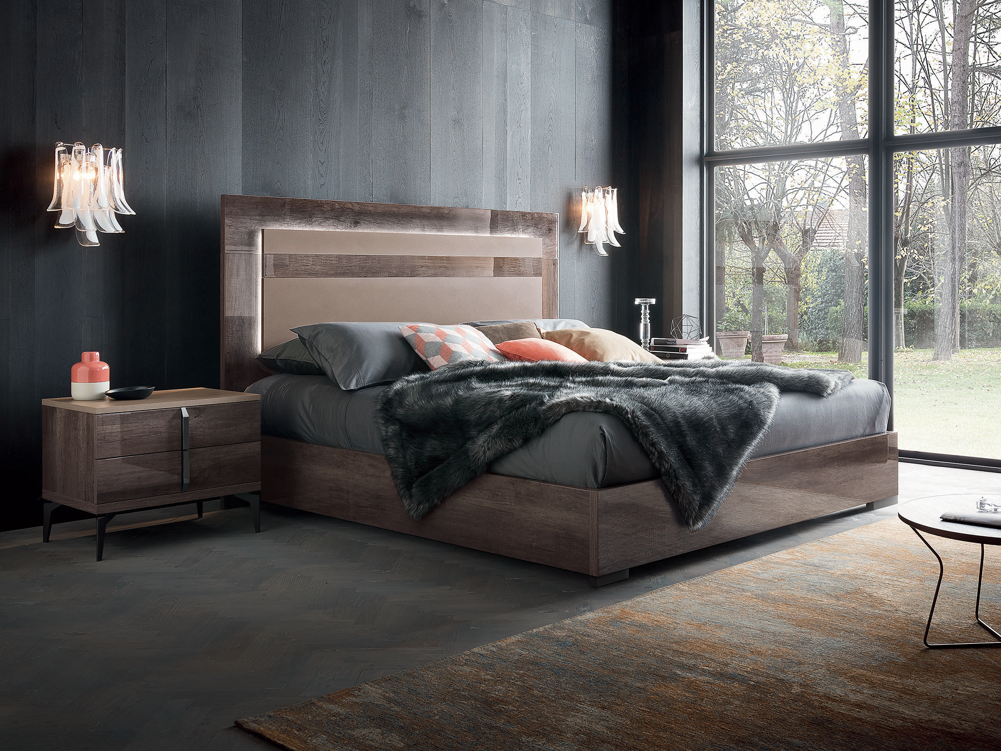 Alf Italia Matera Collection — ultra-modern bedroom featuring a platform bed in a high-gloss Rim Surfaced Oak finish with a backlit, grain-matched headboard and matching two-drawer nightstand on sleek black metal legs.