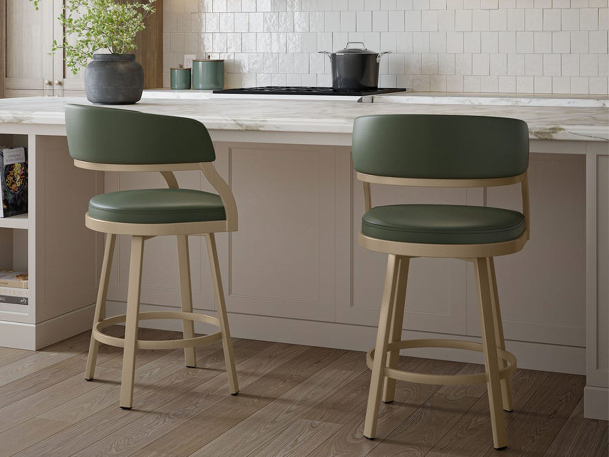 Amisco — contemporary kitchen island featuring two swivel counter stools with forest green upholstered seats and curved backs on a matte gold metal frame, set against a white marble countertop and neutral tiled backsplash.