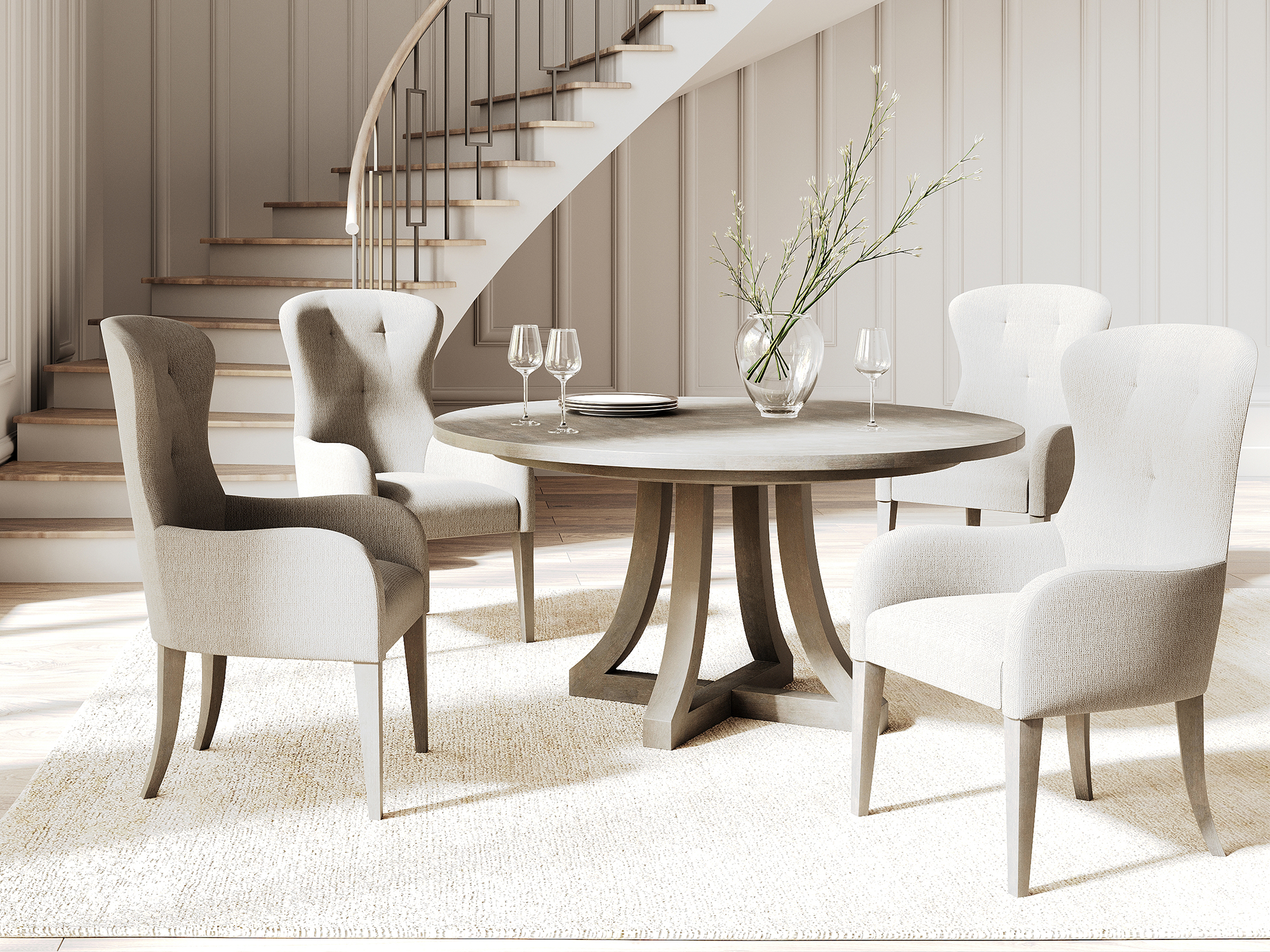 Bernhardt Cornelia — elegant transitional dining room featuring a round stone-top pedestal table with a curved wood base, paired with light gray button-tufted wingback dining chairs.