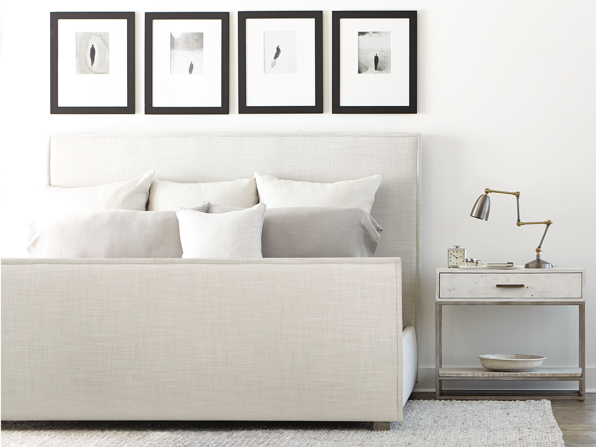 Bernhardt Loft Highland Park — modern industrial bedroom featuring a panel-style bed with a rustic light-wash wood finish, paired with a matching nightstand and an abstract black-and-white area rug for a cool, neutral aesthetic.