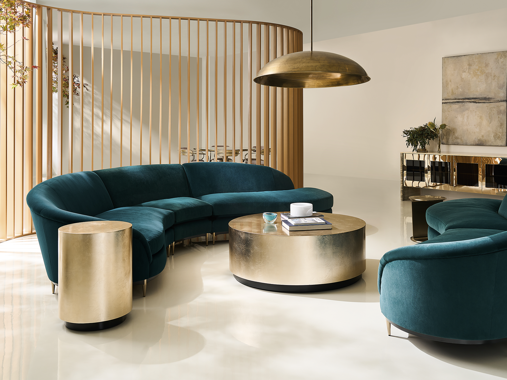 Caracole Classic — contemporary modular sectional sofa in a deep blue textured upholstery featuring a curved end chaise, low-profile silhouette, and a dark wood plinth base