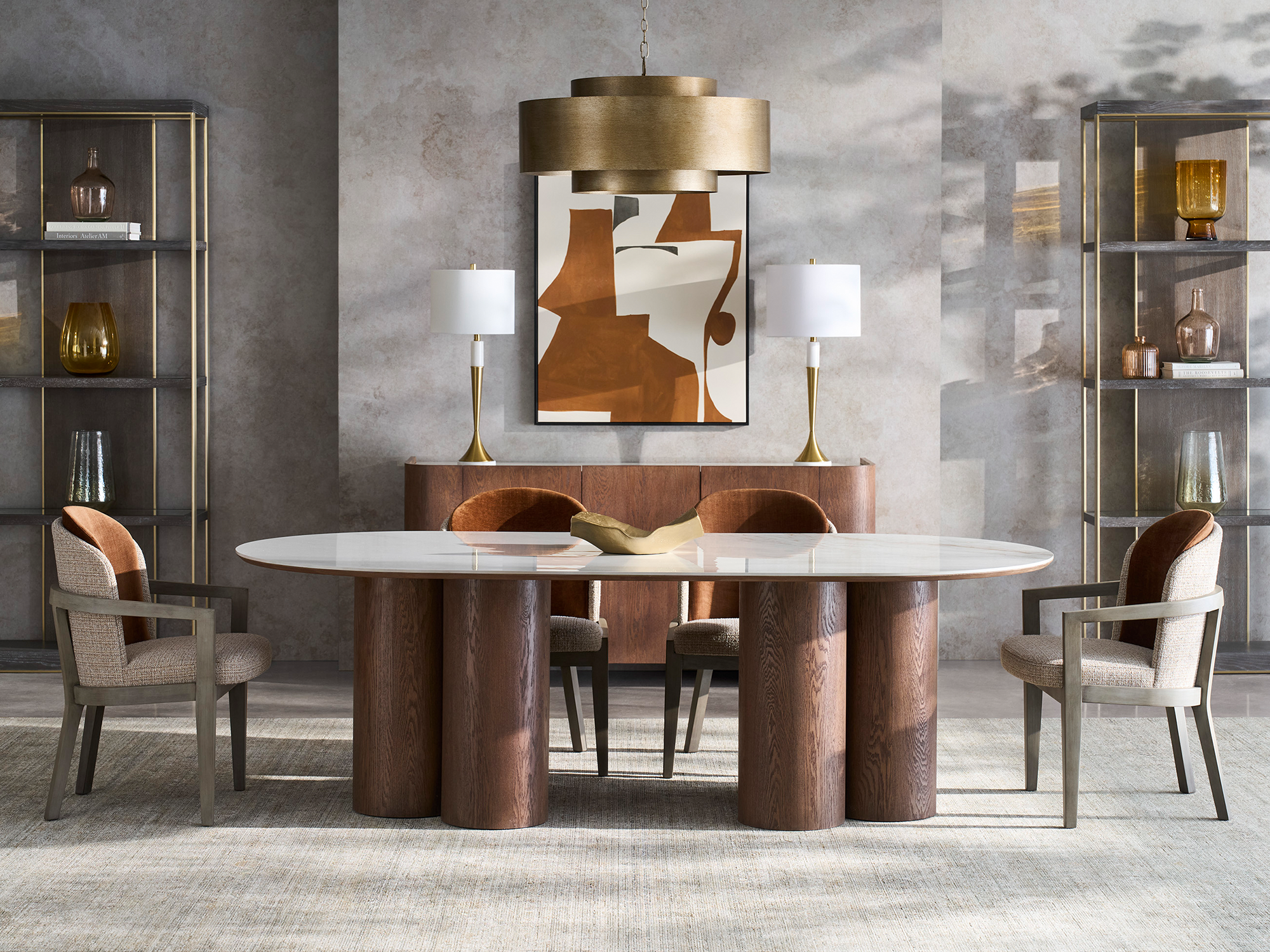 Fairfield Dining — Westwood table with white marble top and four oak pedestals, paired with Theodora tri-tone chairs in rust velvet and taupe bouclé. An architectural, sophisticated dining space featuring unique materials and grey wood frames.