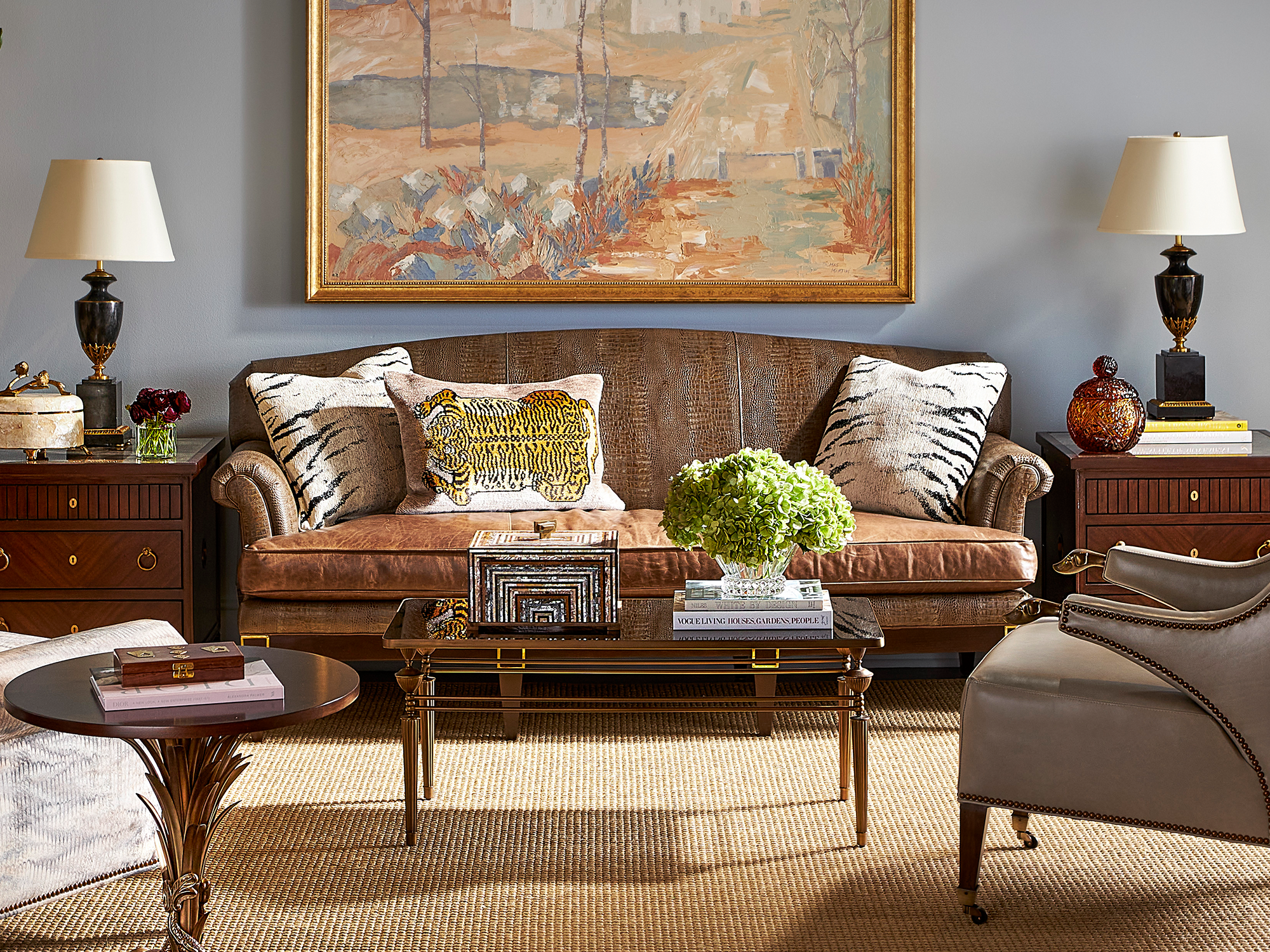 Hancock & Moore CDJ Collection — curated maximalist living room featuring an embossed-crocodile leather sofa, whimsical tiger-patterned pillows, and a palm-inspired bronze martini table.
