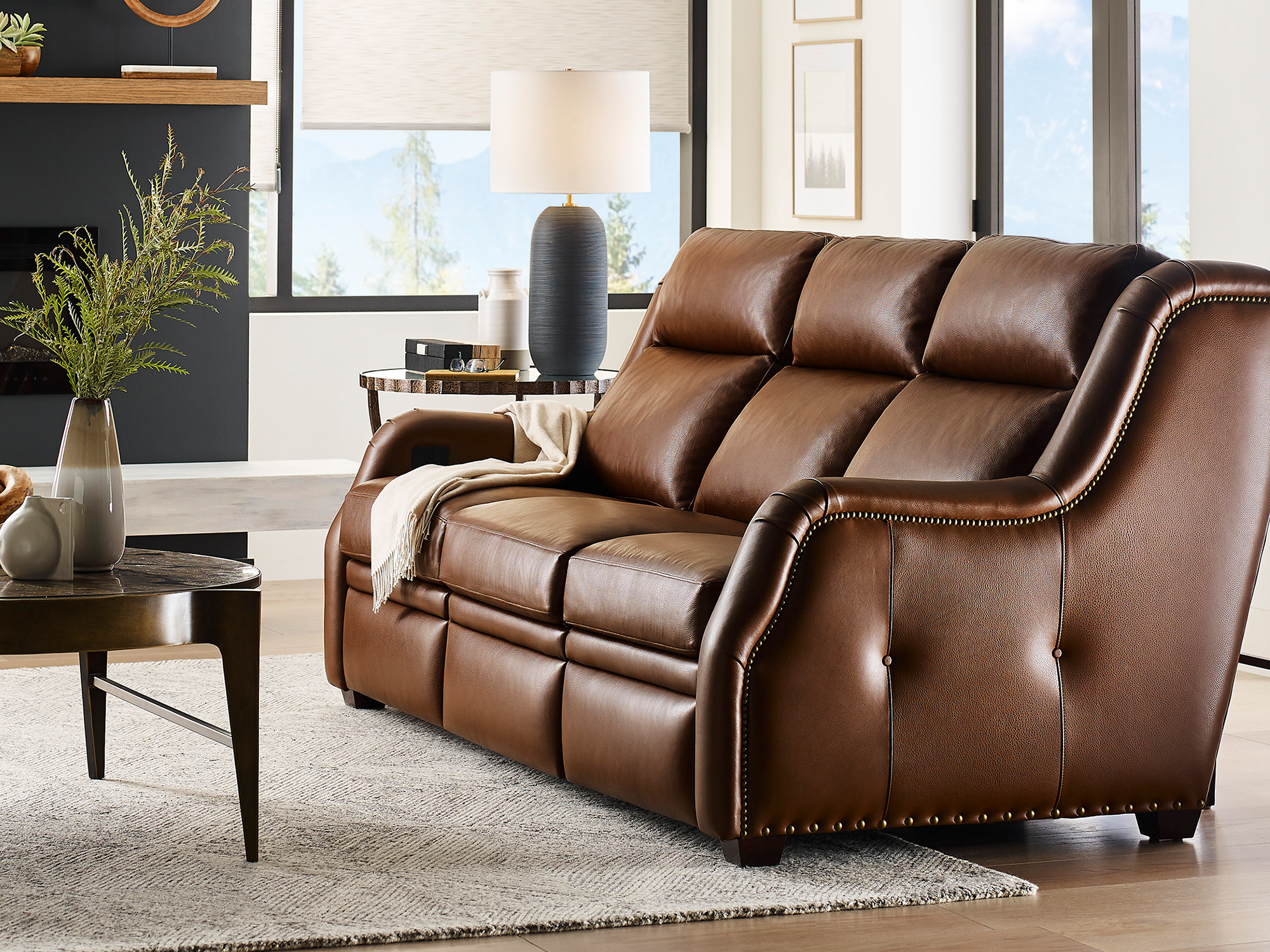 Hancock & Moore Motion Your Way — cozy transitional living room featuring a power-reclining leather sofa in a deep slate blue, a warm wood coffee table, and comfortable family-friendly styling.