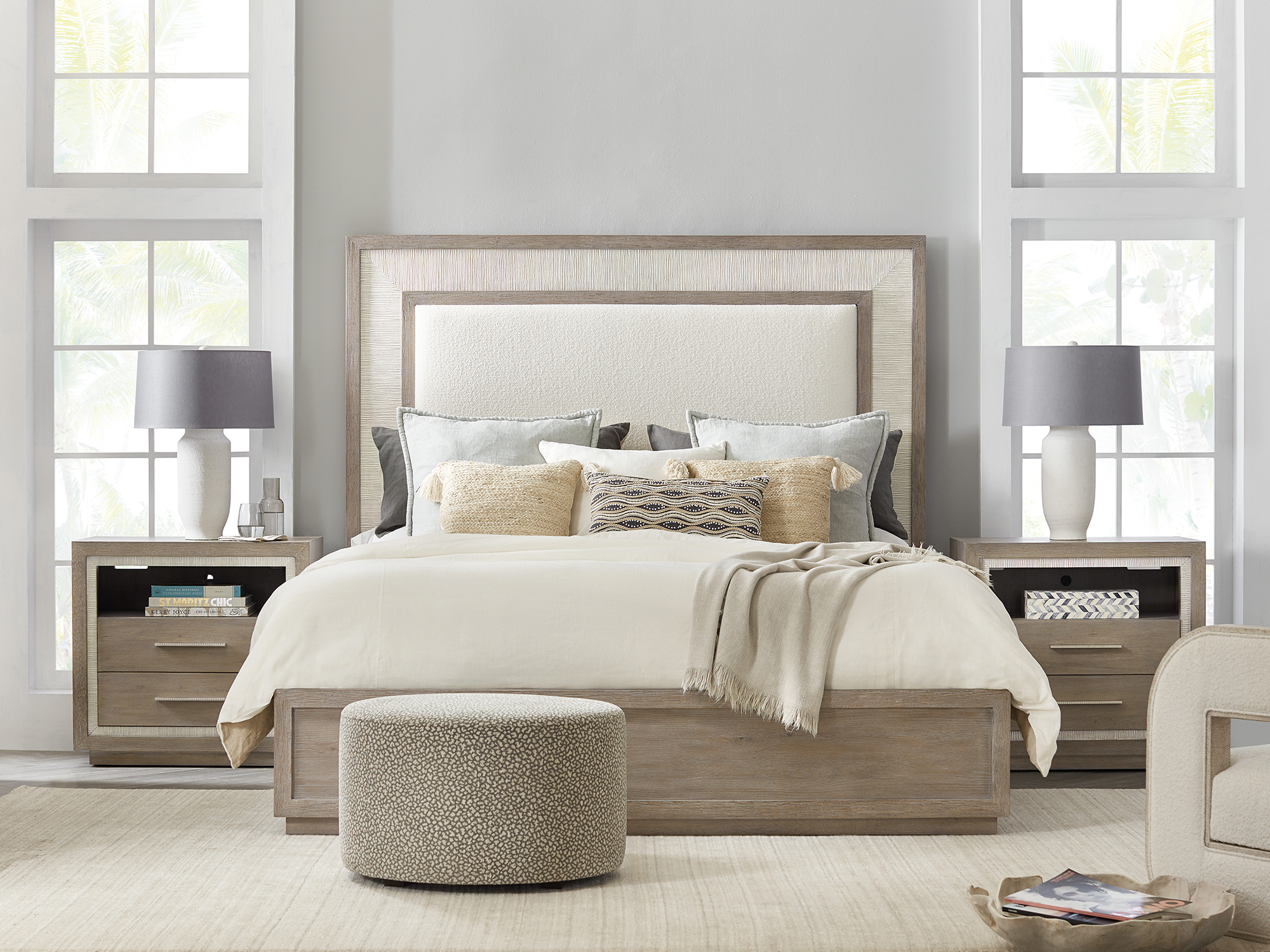 Hooker Furniture Serenity — tranquil contemporary bedroom featuring a light-oak panel bed with a white-sand textured headboard, matching three-drawer nightstands, and soft coastal accents.