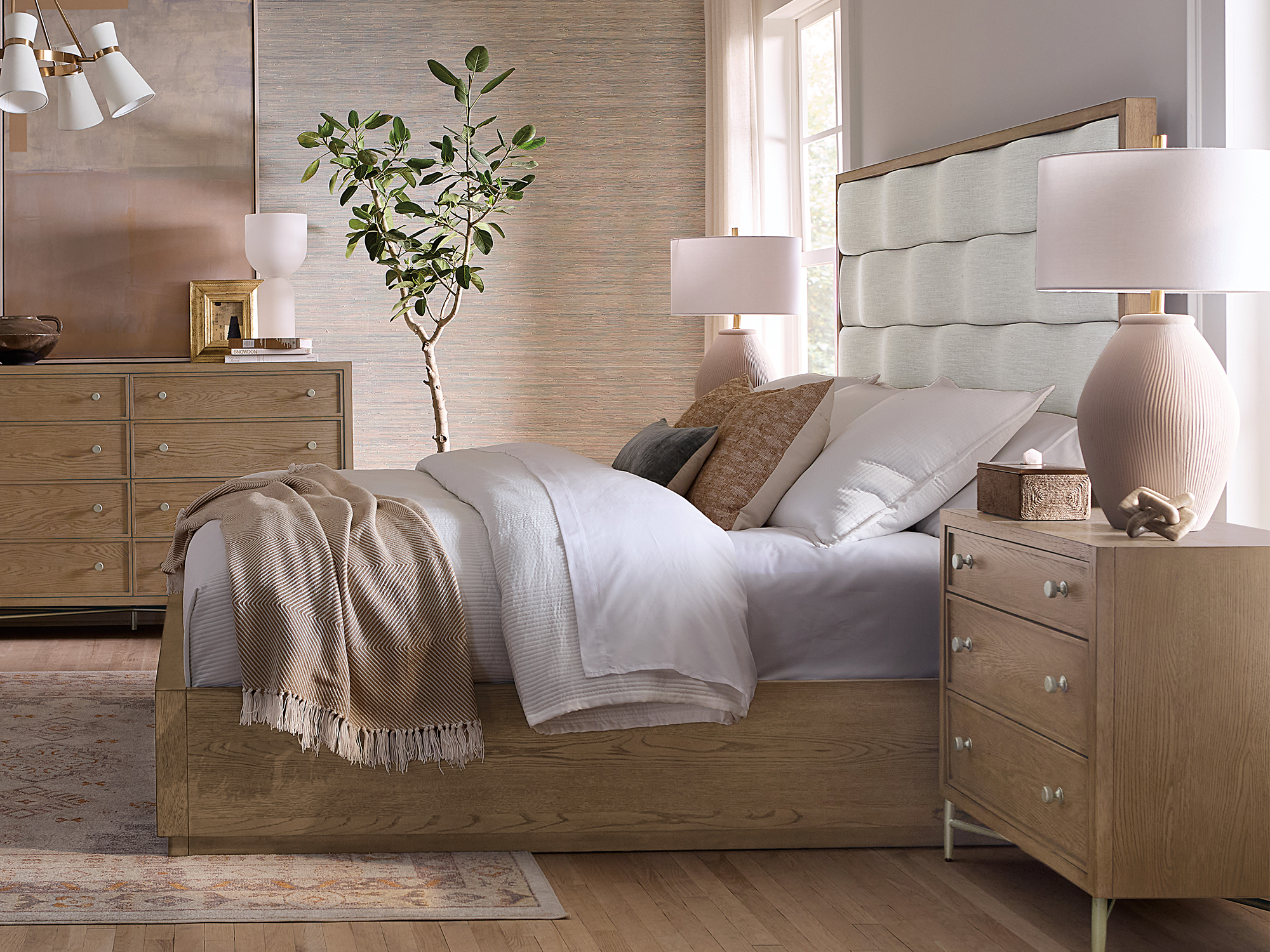 Hooker Furniture — Sonnet collection soft modern bedroom featuring a channel-tufted upholstered bed with light oak wood framing, a three-drawer nightstand, and a matching double dresser on metal legs.