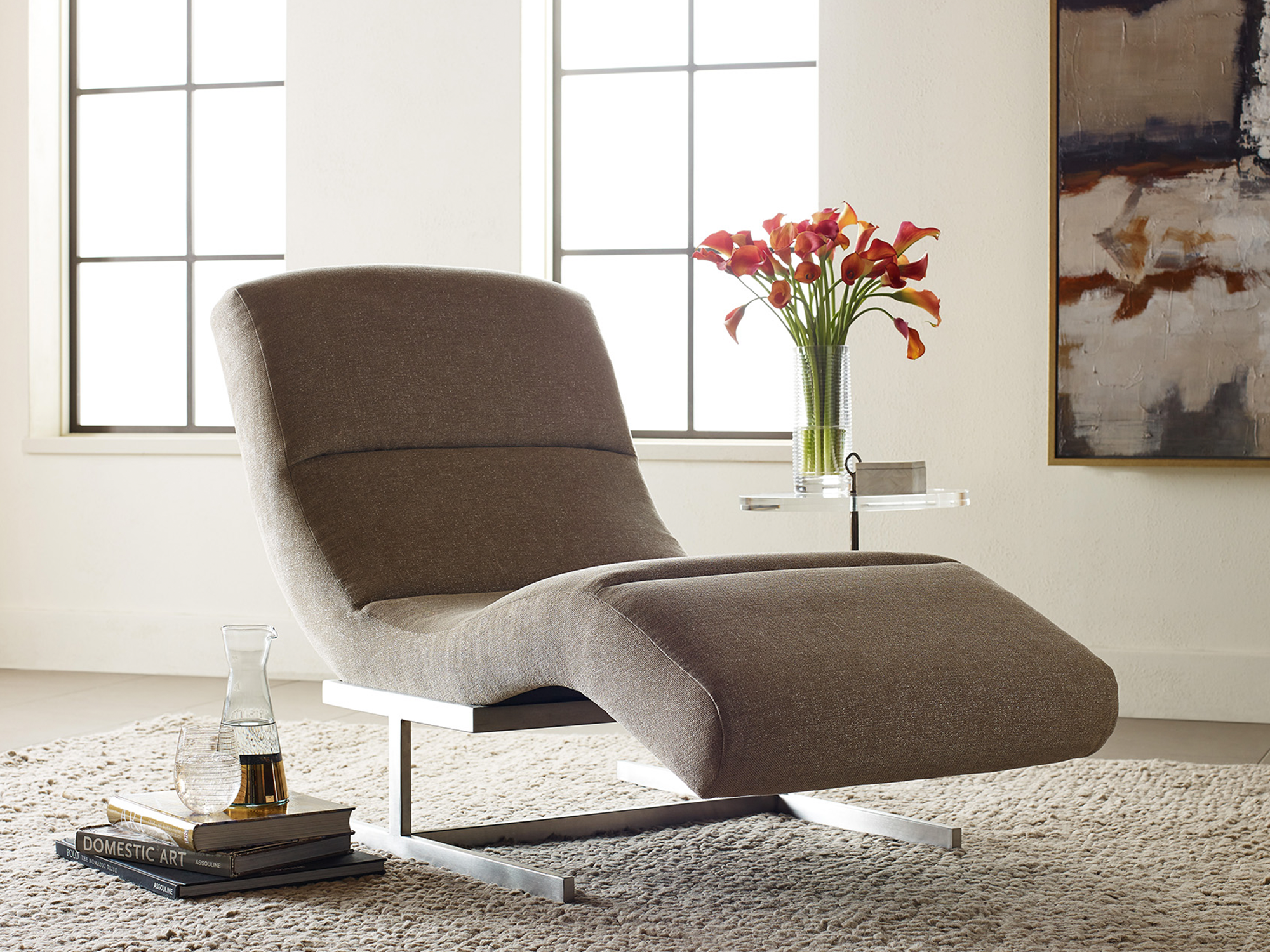 Jessica Charles — a sophisticated, minimalist lounge space featuring a low-profile chaise with an organic, flowing silhouette.