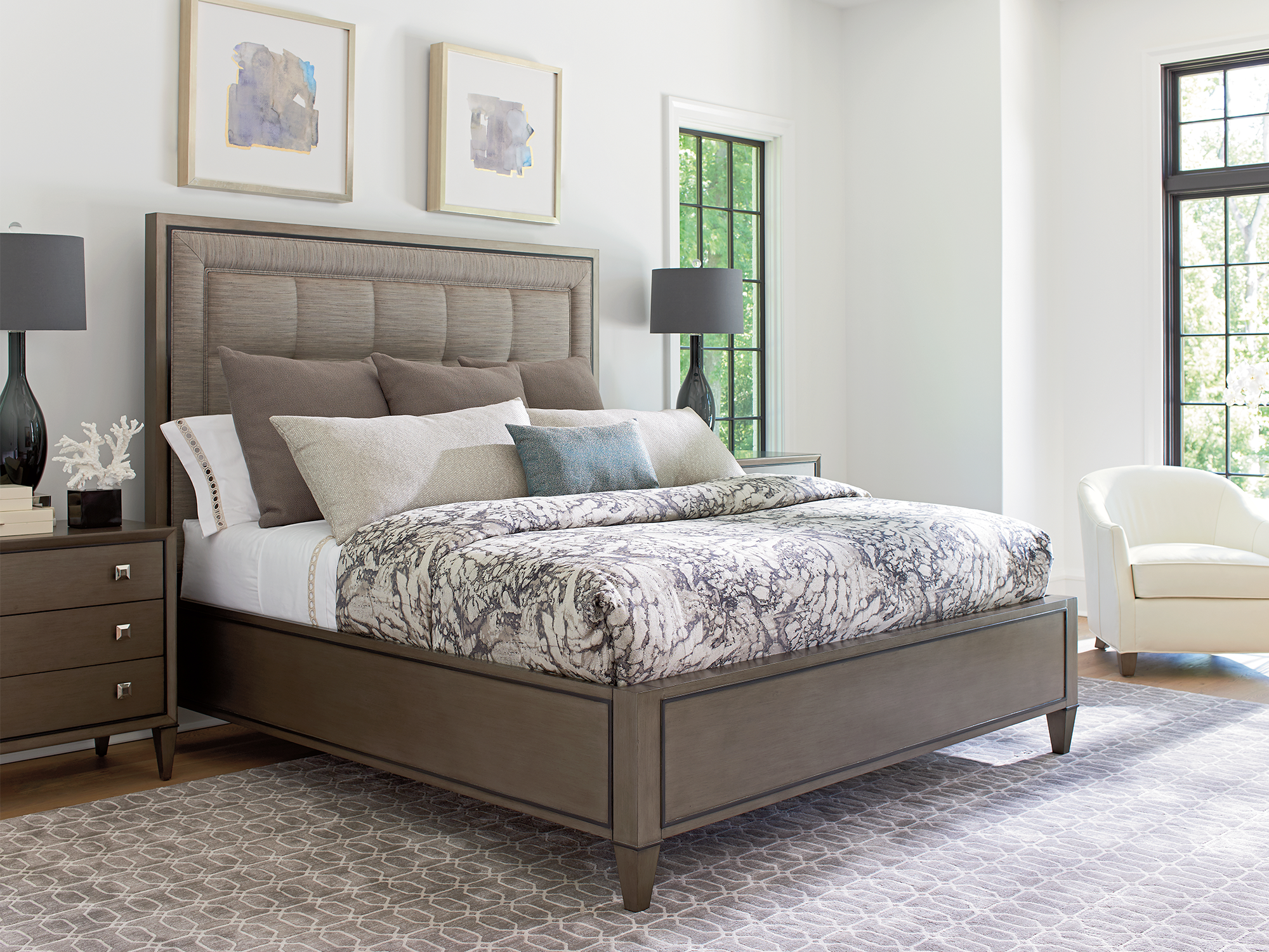 Lexington Ariana — transitional bedroom featuring a greige-finished panel bed with a channel-tufted fabric headboard, a matching three-drawer nightstand, and marble-patterned bedding.